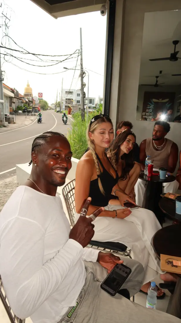Guests at the window seat looking out over the road in Munggu