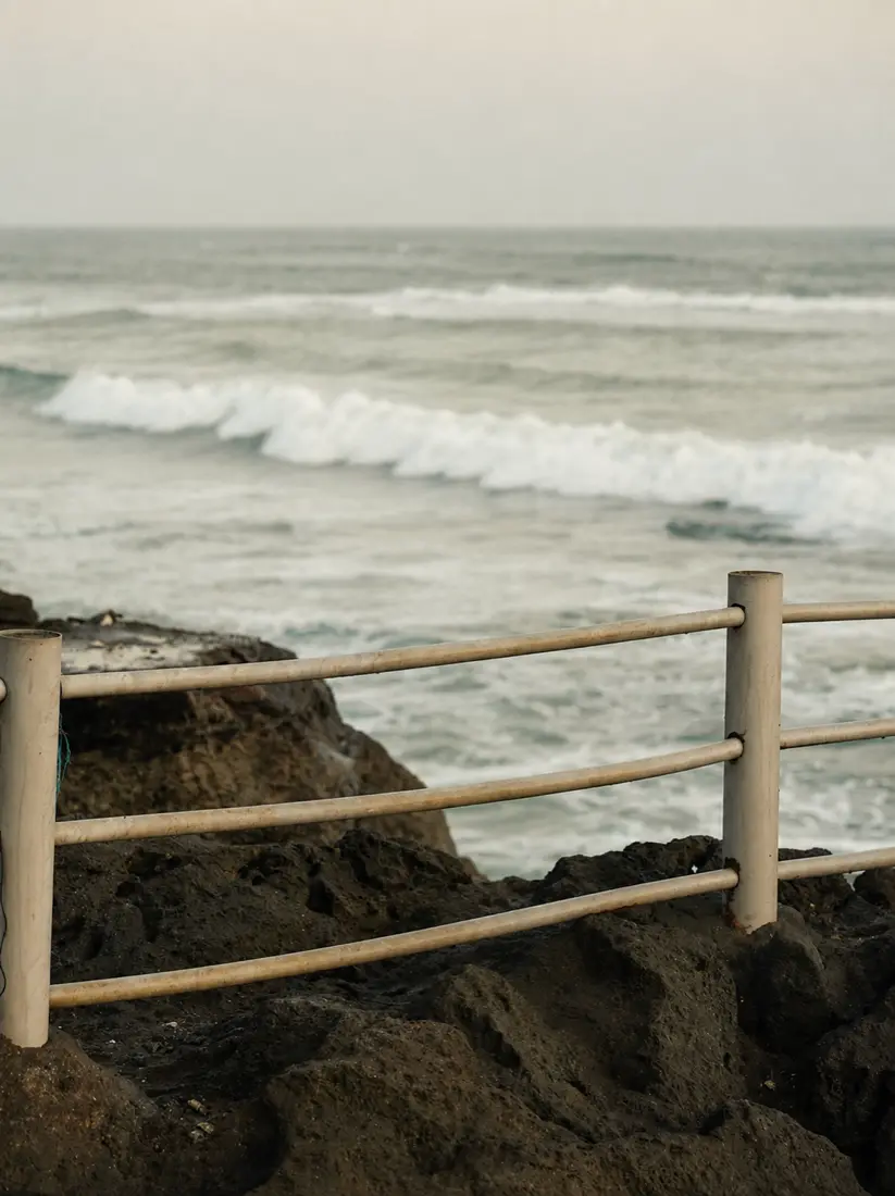 A wave breaking off the rocks on the coast near Seseh